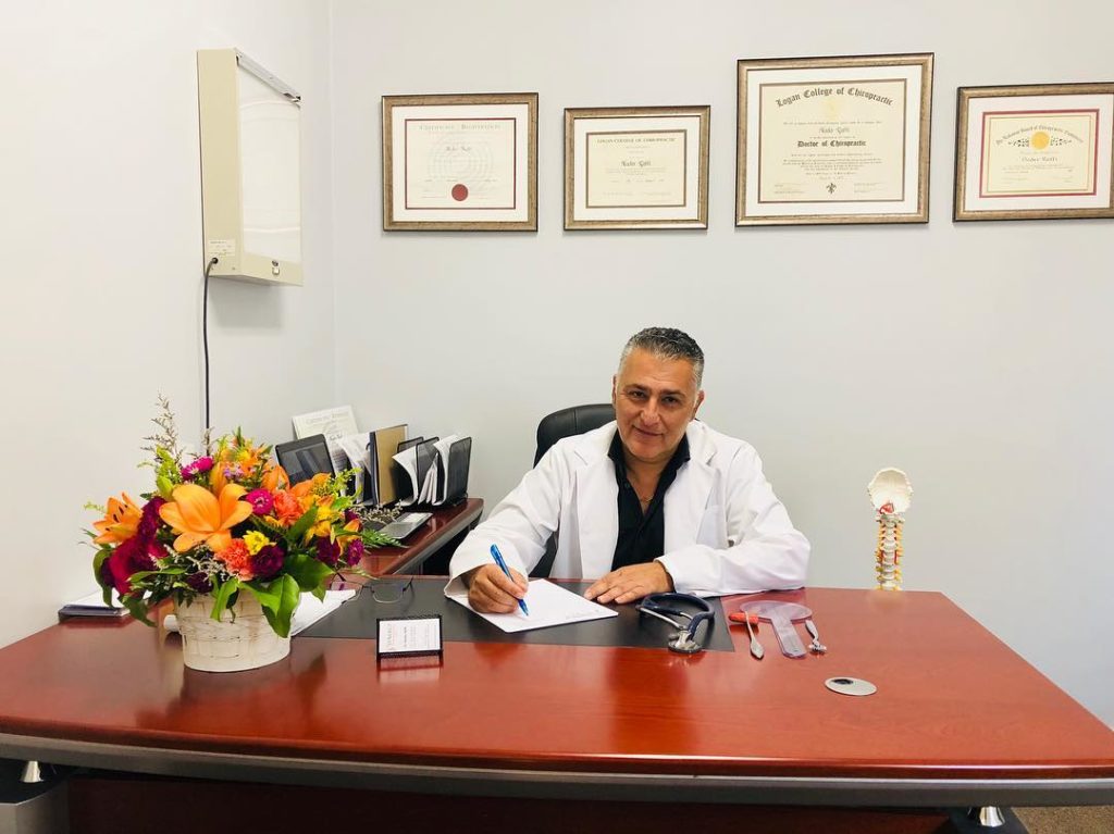 Dr. Nader Raffi D.C., M.D. in his office at Synergy rehab and sports clinic Toronto