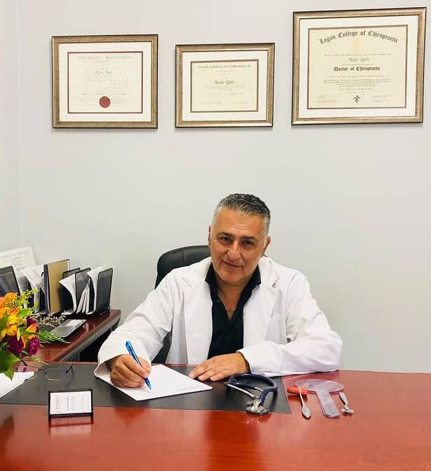 Dr. Nader Raffi D.C., M.D. in his office at Synergy rehab and sports clinic Toronto